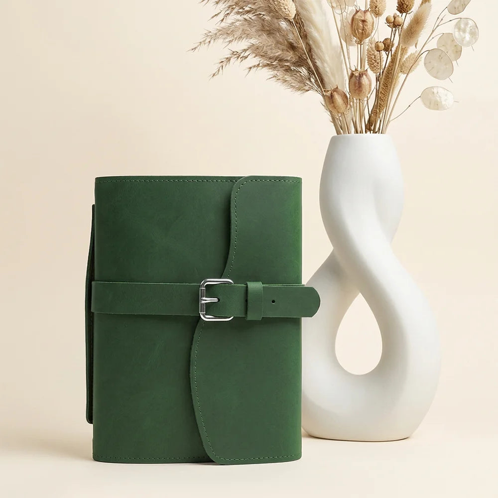 Handmade leather journal case featuring interior pockets, pen holder, built-in bookmark, and comfortable outer handle.