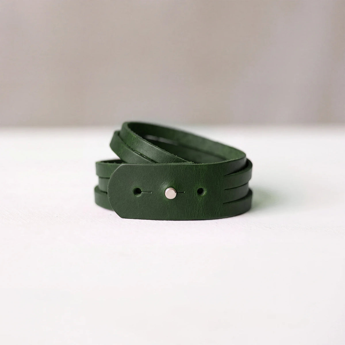 Elegant handcrafted leather bracelet with minimalist design and reliable snap button fastening.