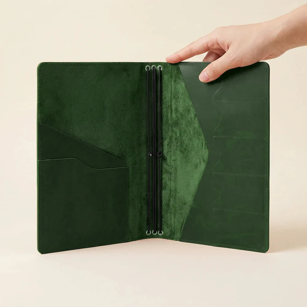 Genuine leather notebook holder with organized interior layout and refillable elastic notebook loops.