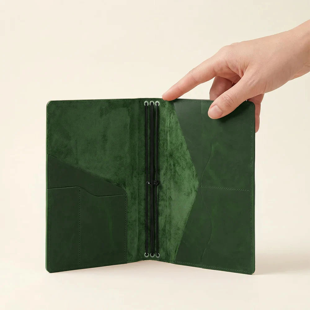 Premium leather notebook cover designed with three elastic bands and spacious inner pockets.