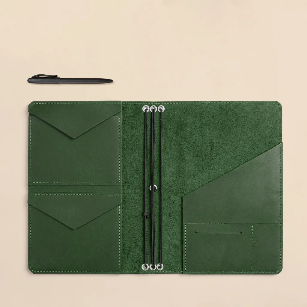 Leather notebook cover designed for planners with elastic notebook loops and storage sleeves.