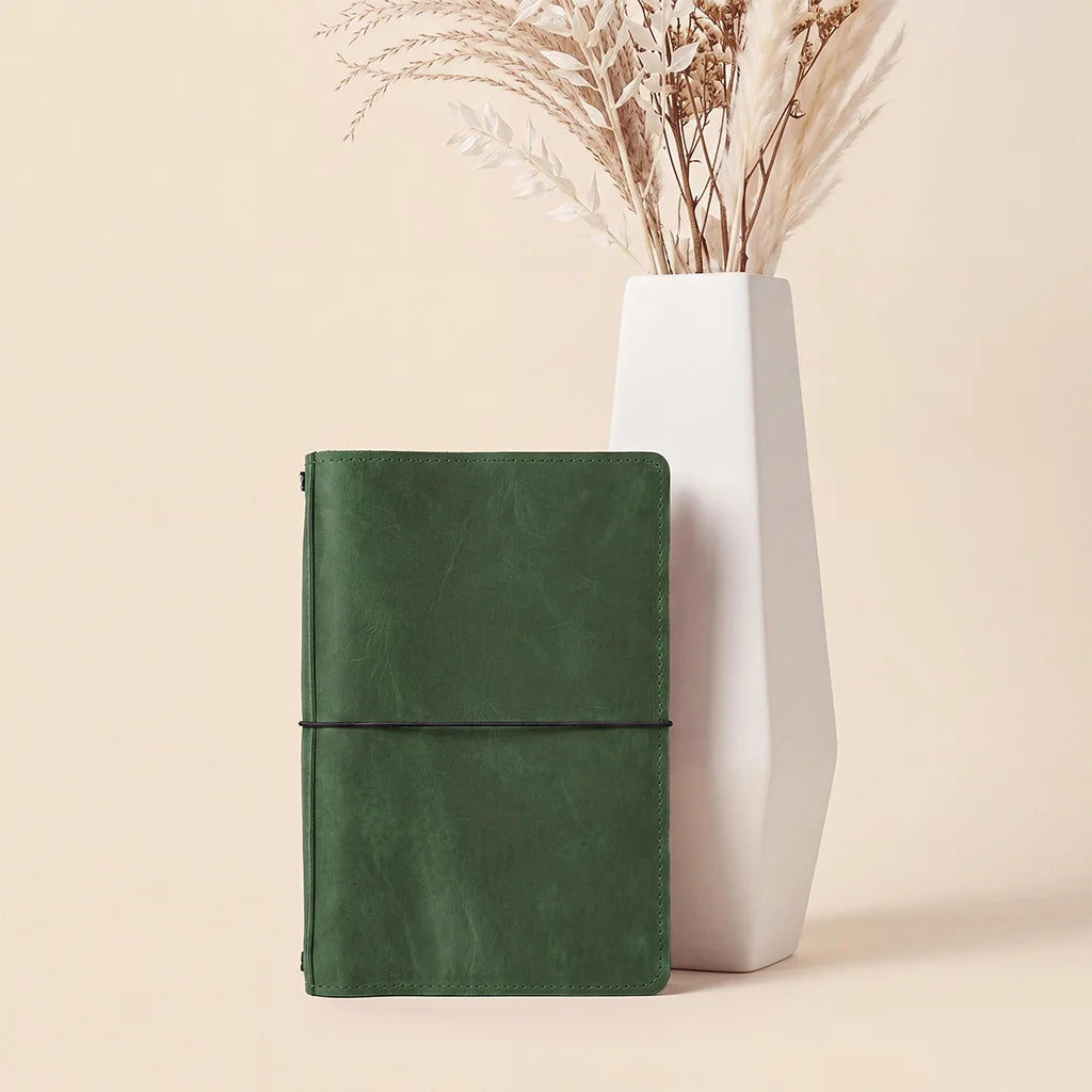 Genuine leather journal cover offering organized interior pockets for everyday essentials.