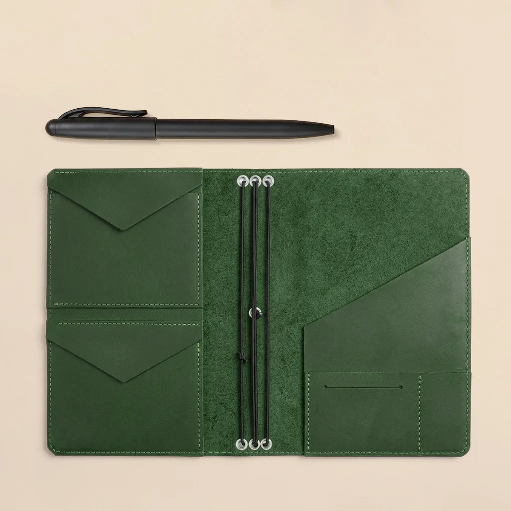 Refillable leather notebook cover designed with organized pockets and flexible elastic insert holders.