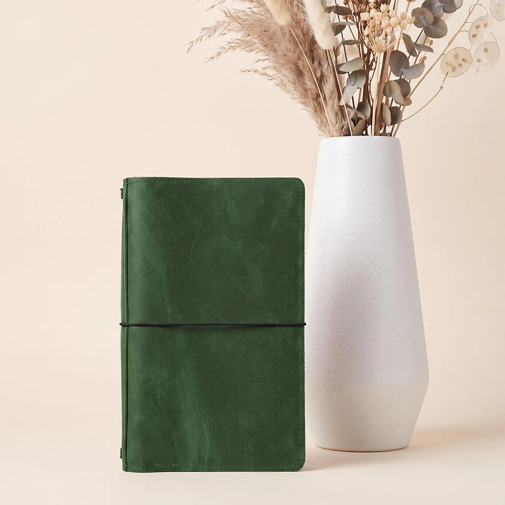 Elegant leather notebook cover offering organized interior storage and secure elastic notebook loops.
