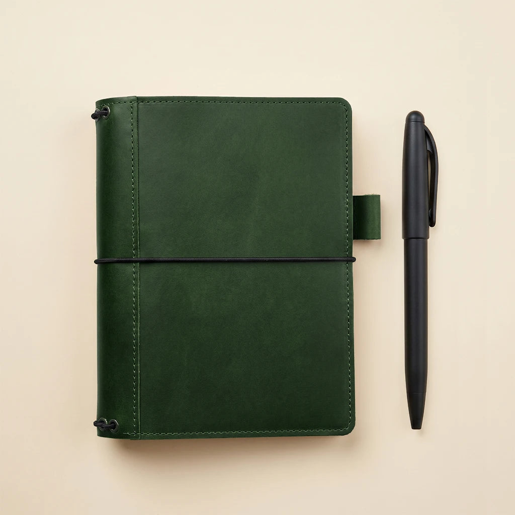 Minimalist leather notebook cover with interior pockets and secure elastic bands