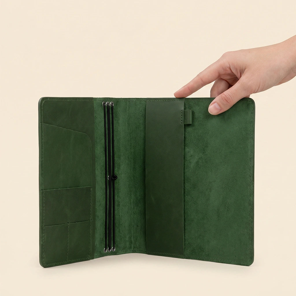 Genuine leather refillable notebook holder with flexible elastic bands and pen loop.