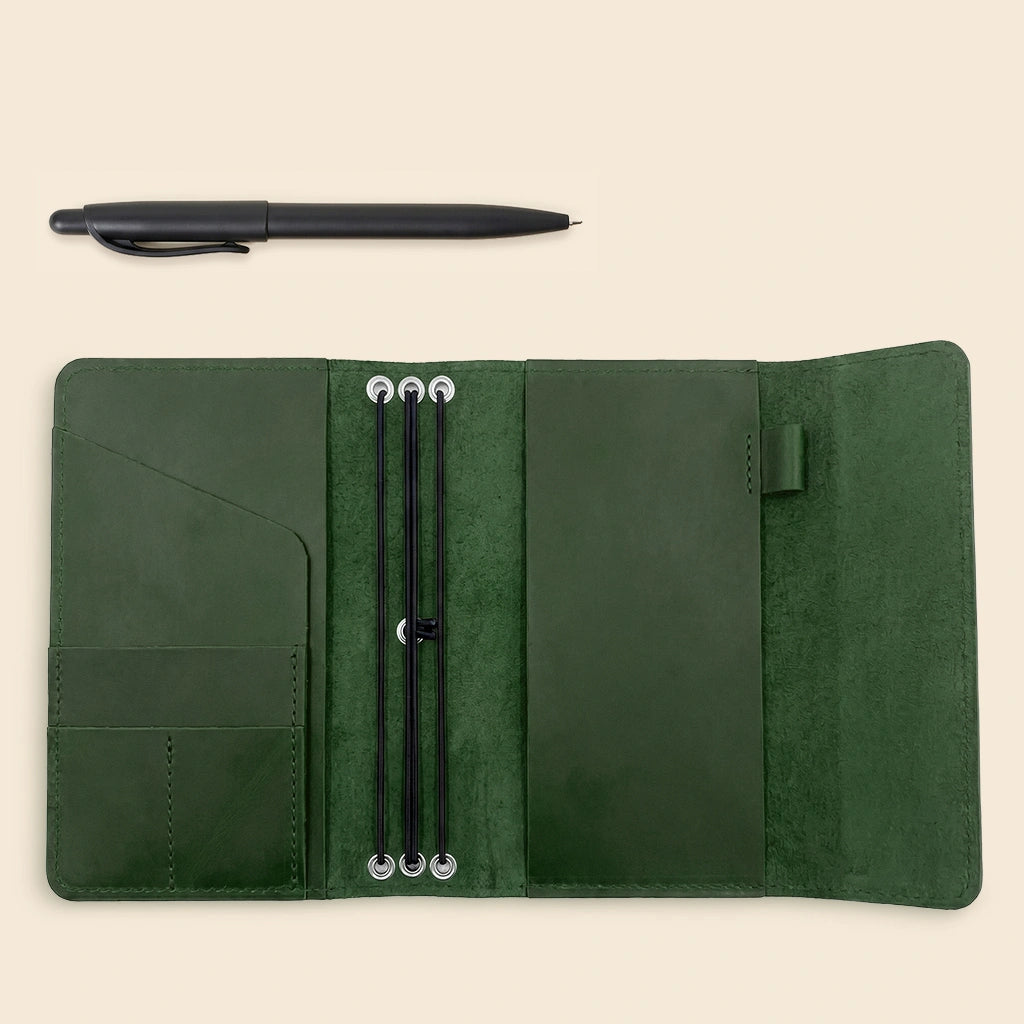 Leather notebook organizer crafted from genuine leather with pen loop and card slots.