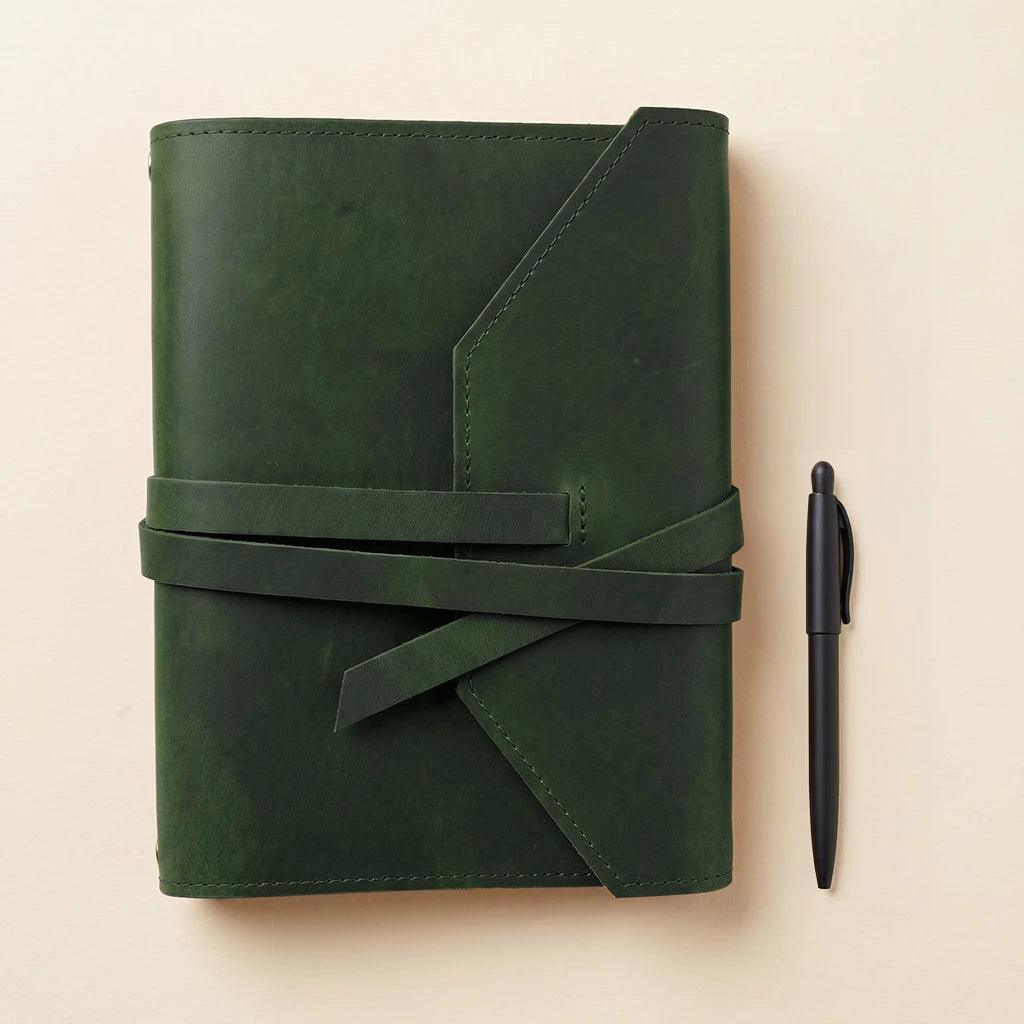 Leather notebook wrap keeping notebooks organized and pens always within reach.