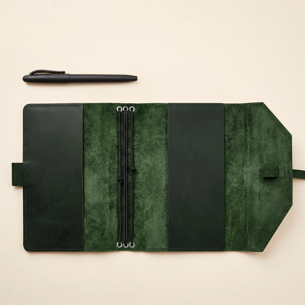 Premium leather notebook wrap with flexible closure and attached pen holder.