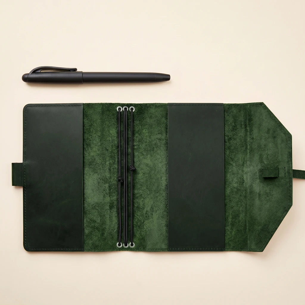 Genuine leather journal cover featuring elastic bands and pen holder detail.