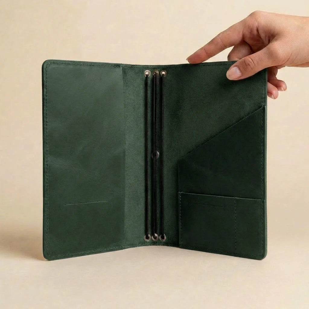 Green leather wallet held open by a hand on a beige background