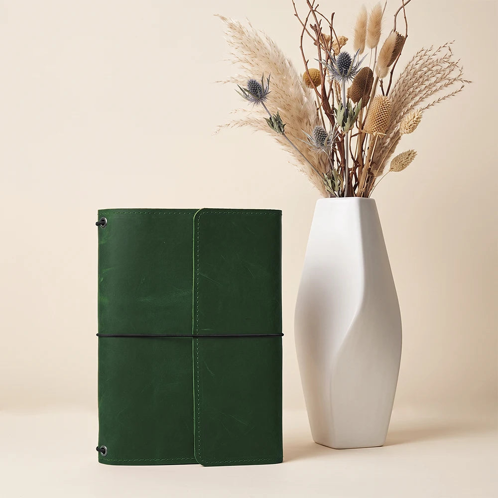 Premium leather notebook case crafted for organized journaling and flexible insert replacement.