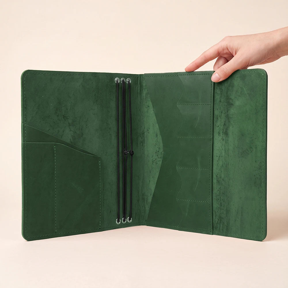 Handmade leather notebook cover with practical organization for notebooks, pens, and small essentials.
