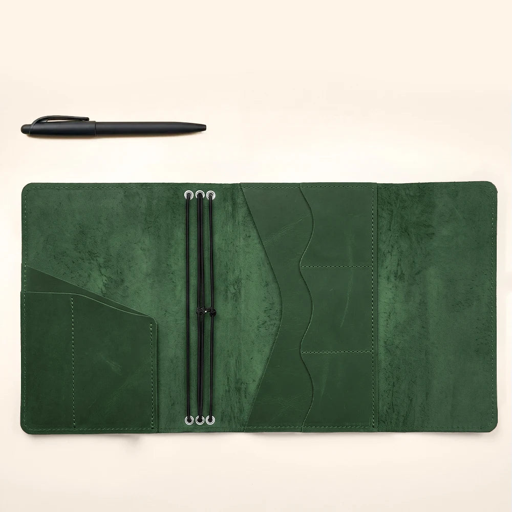 Leather notebook sleeve with elegant handcrafted stitching and secure elastic journal holders.