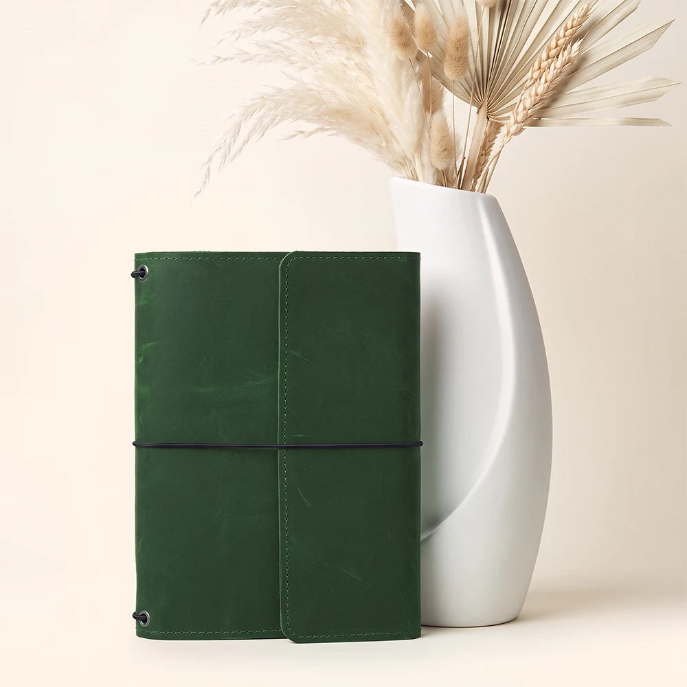 Handmade refillable journal organizer with premium leather construction and practical inside compartments.