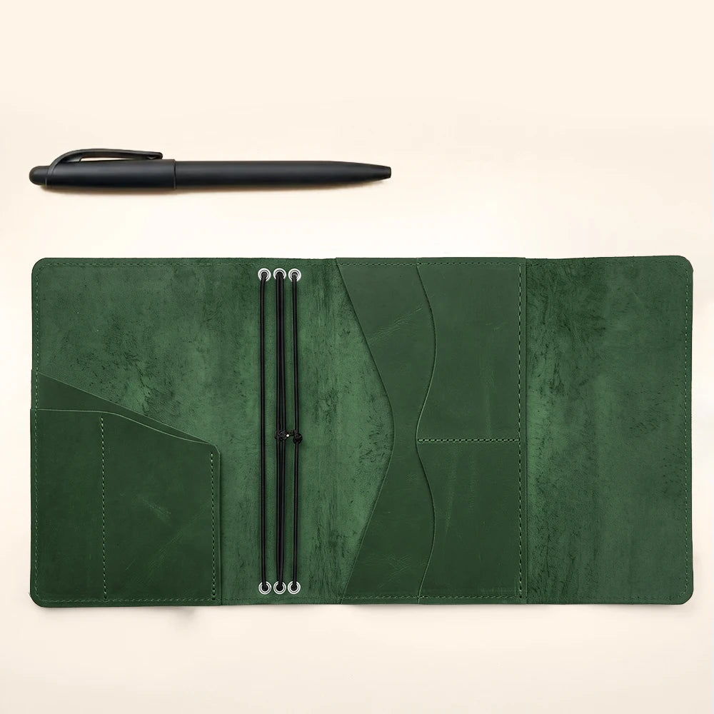 Handmade leather travel journal cover with interior pockets and three notebook elastic bands.