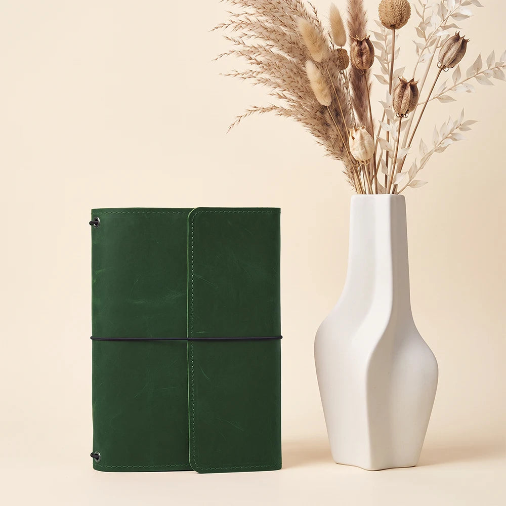 Genuine leather notebook organizer with refillable insert system and functional storage compartments.