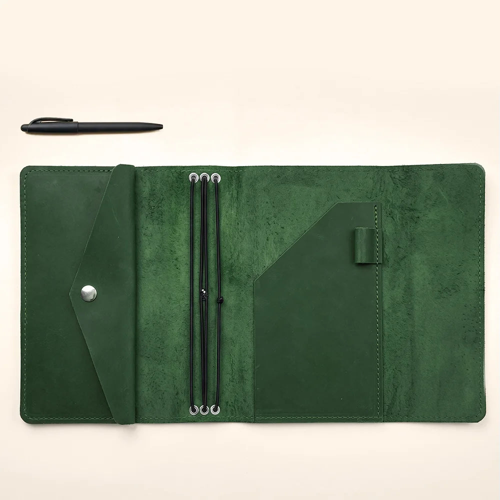 Leather notebook sleeve featuring secure elastic notebook holders and handcrafted premium leather construction.