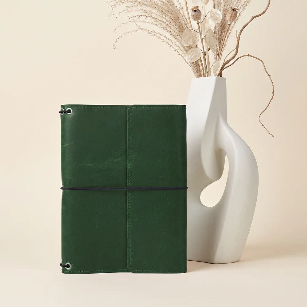 Stylish refillable journal organizer with durable leather exterior and functional storage design.