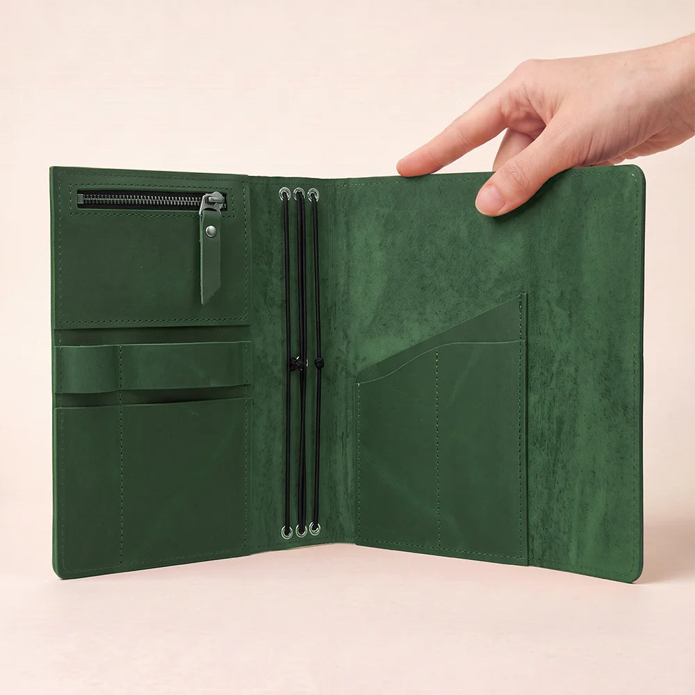 Handmade leather notebook cover featuring spacious pockets and an integrated pen loop