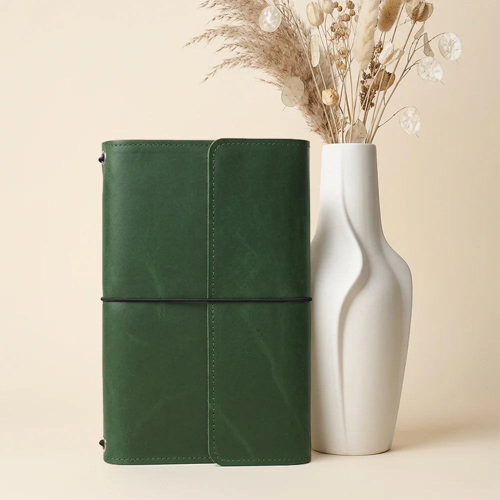 Handcrafted leather journal case designed with organized storage compartments and convenient pen placement.