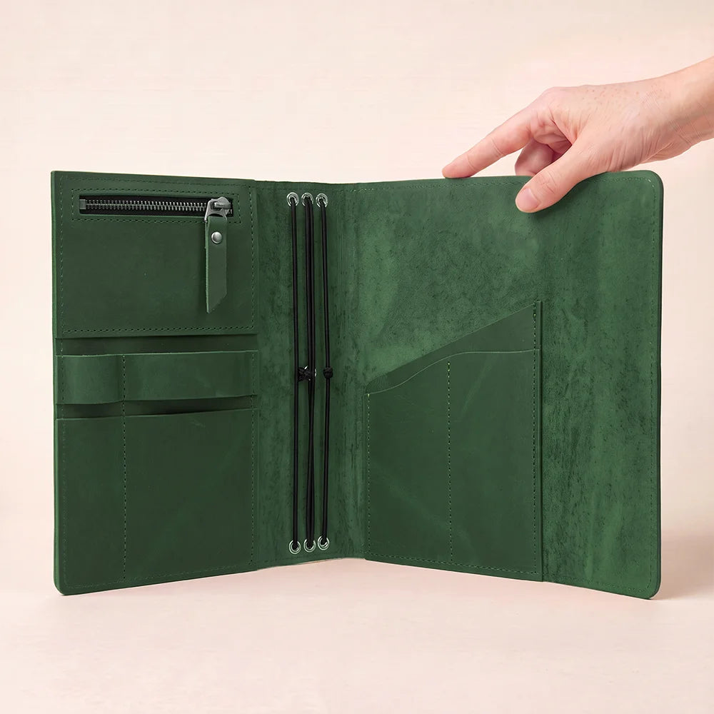 Natural hide notebook cover with carefully stitched pockets and an integrated elastic pen keeper.