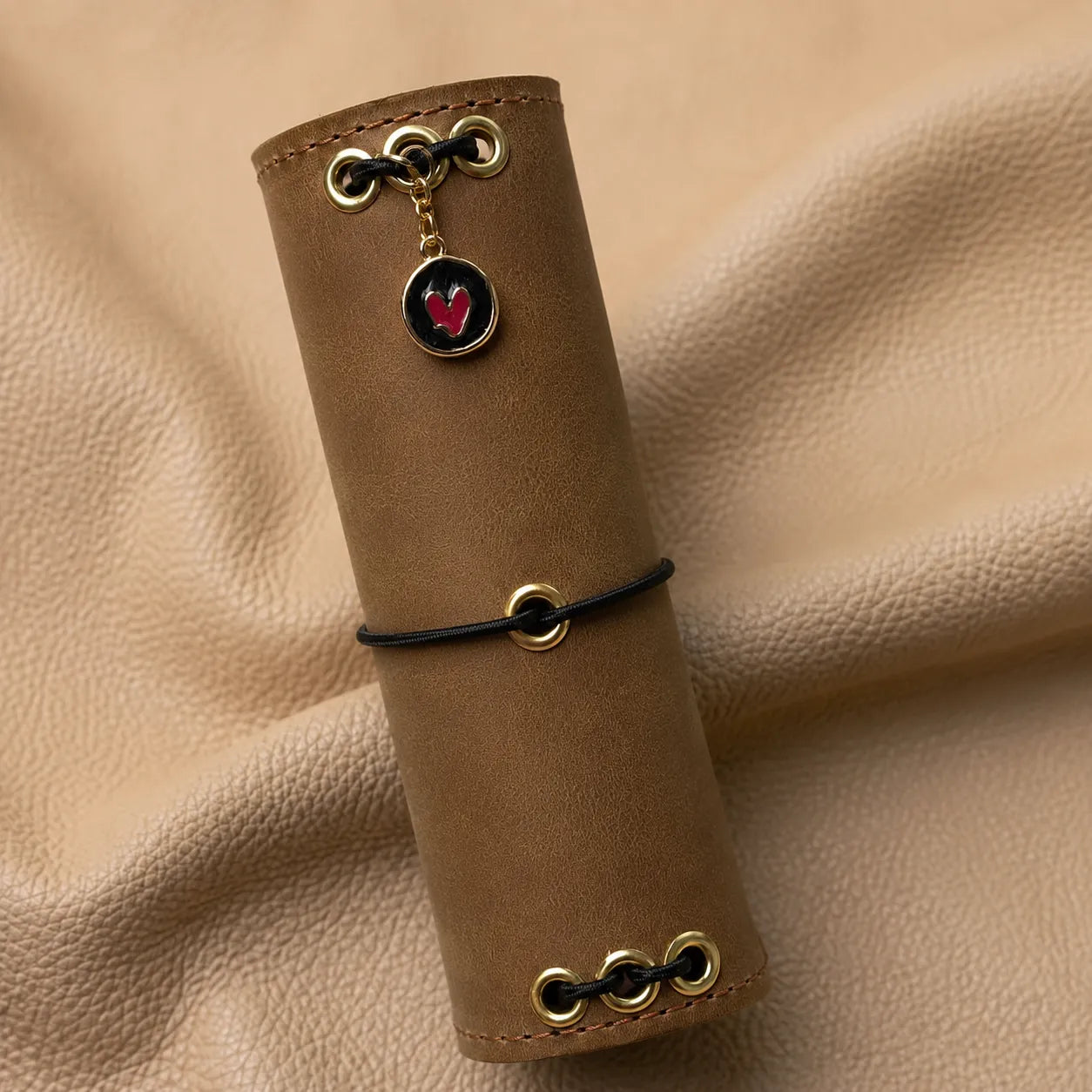 Heart Cup Journal Charm attached to a leather notebook elastic, decorative planner accessory.