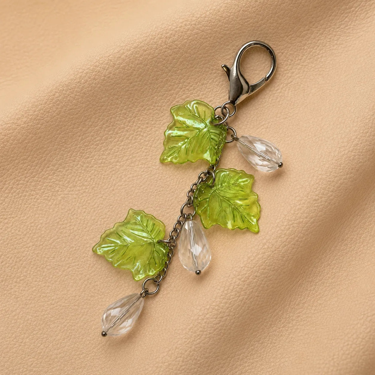 Decorative leaf bead journal charm for notebook elastics, stylish handmade journal embellishment accessory.