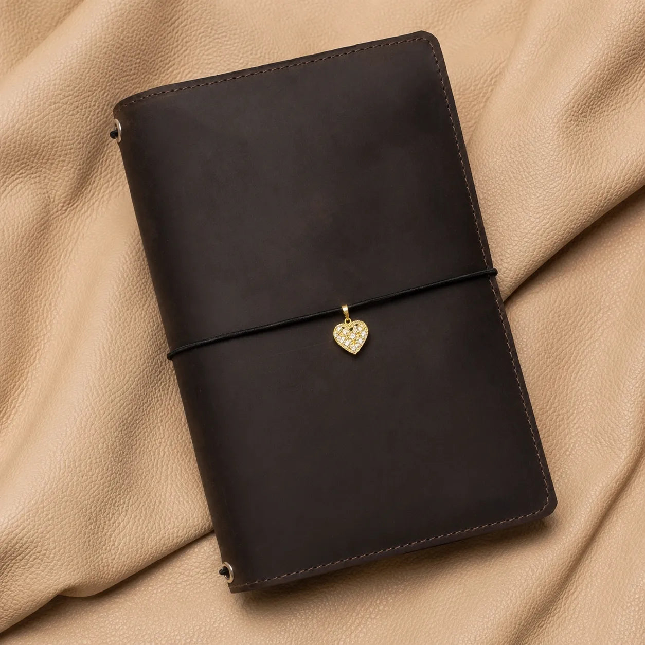 Elegant heart journal charm with metal clasp, designed for refillable leather notebook covers.