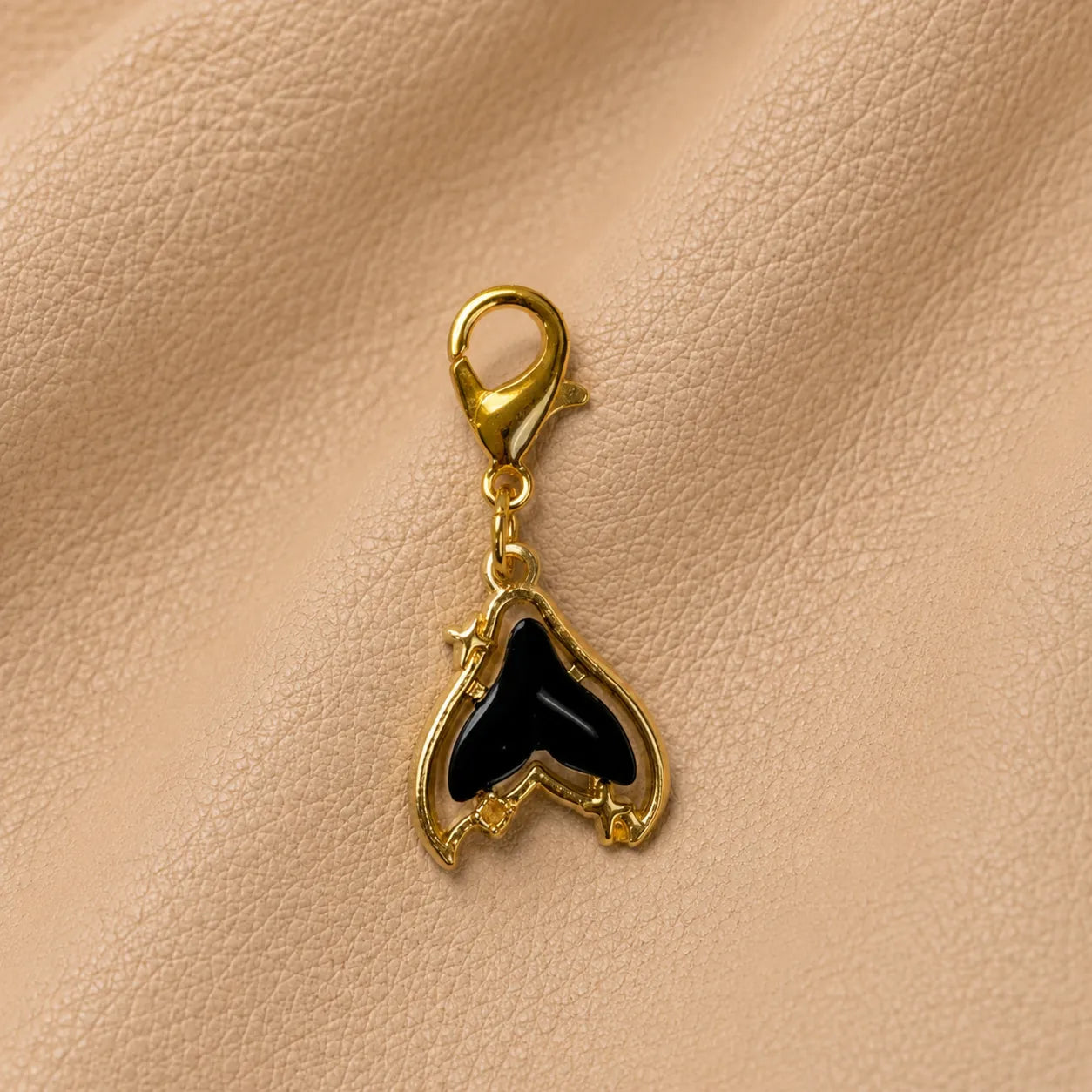 Journal charm with whale tail bead and metal clip accessory.