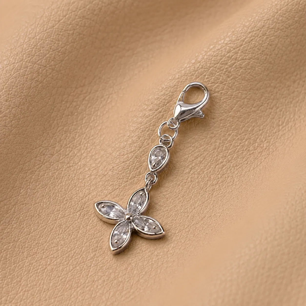 Decorative floral journal charm with beads, stylish notebook accessory secured to elastic bands.