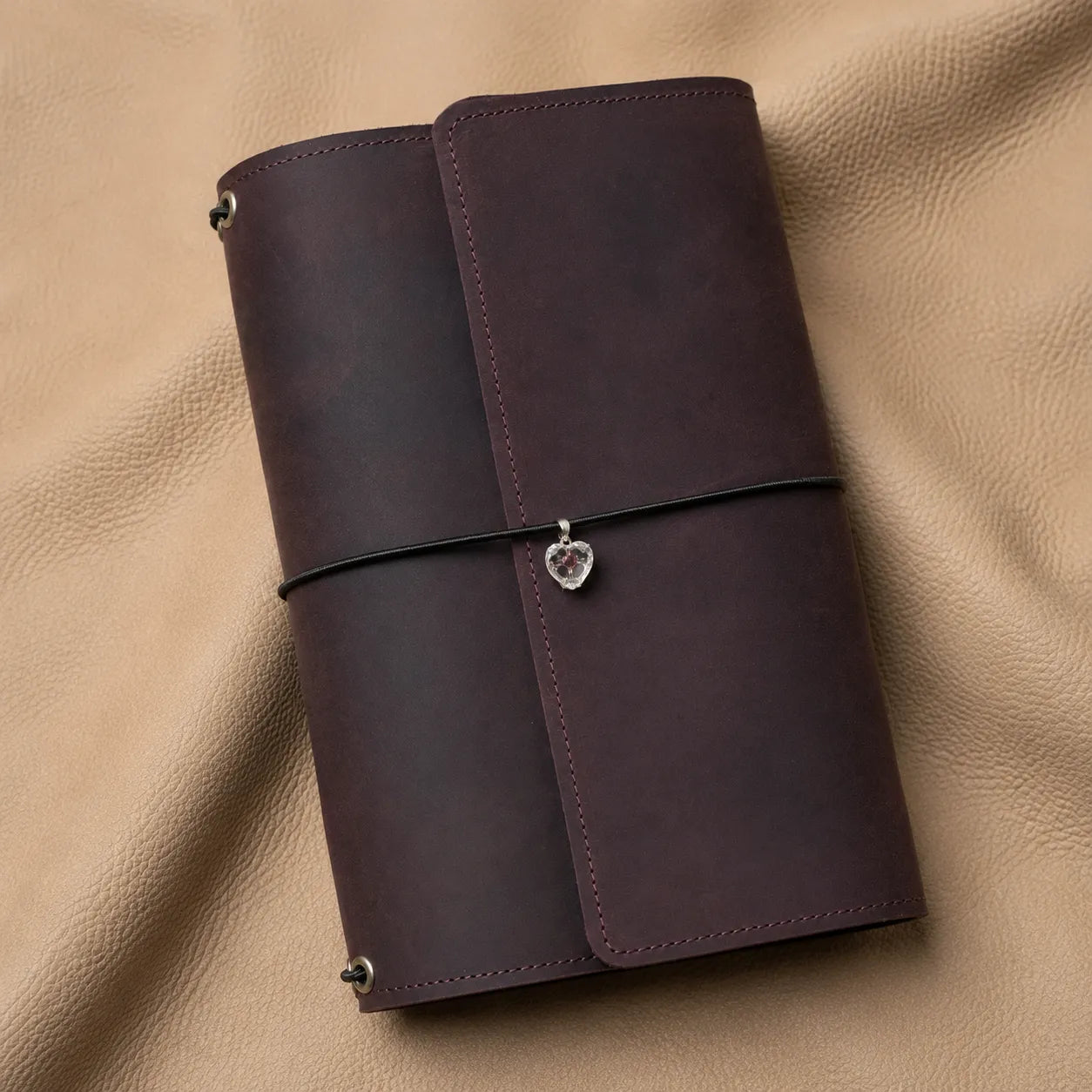 Close-up of a heart journal charm for notebook elastic bands, elegant decorative notebook accessory.