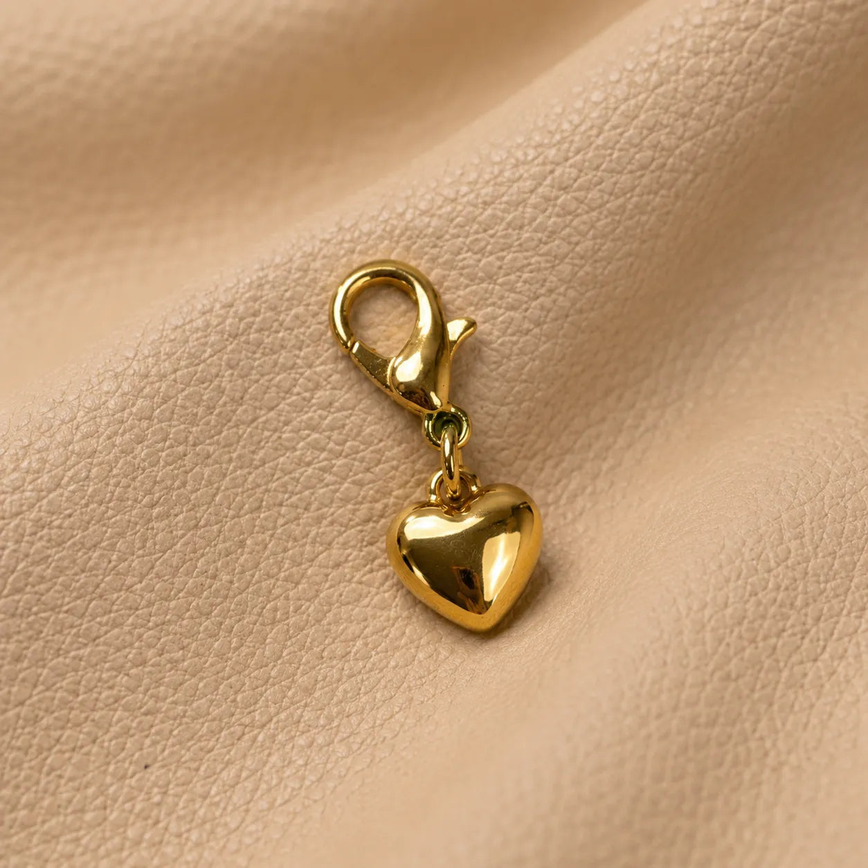 Elegant heart-shaped planner charm secured on notebook elastic, stylish handmade journal decoration.
