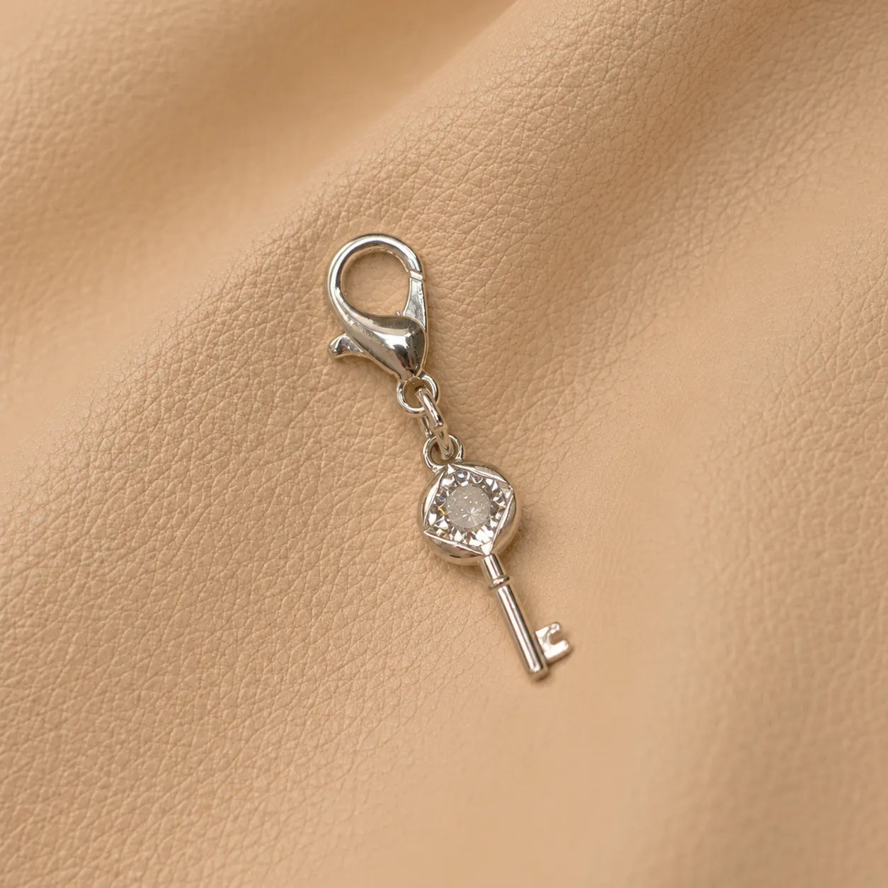 Decorative key-shaped journal charm enhancing a travel notebook with a stylish handcrafted accent.
