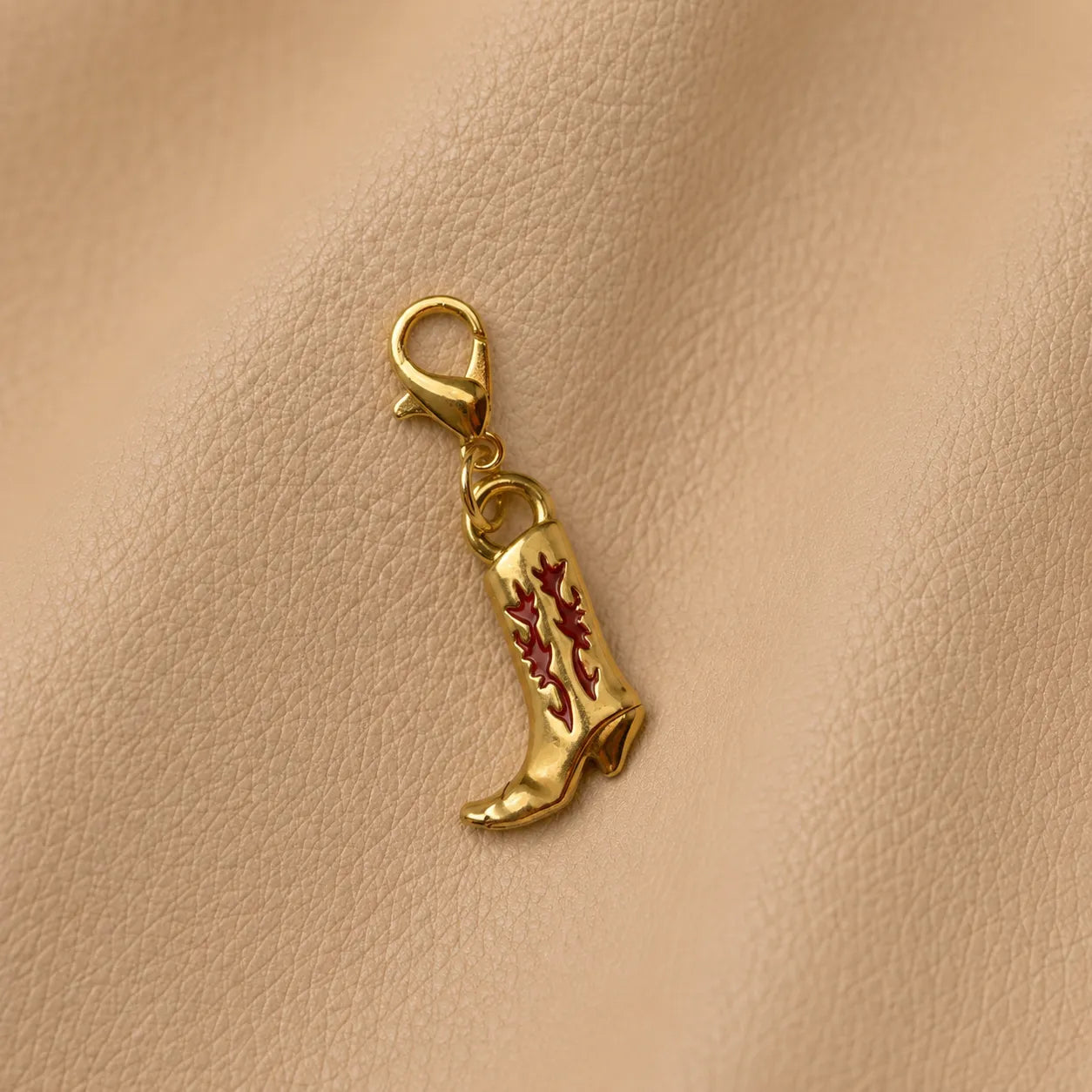 Boot-shaped journal charm attached to elastic notebook band on genuine leather journal cover