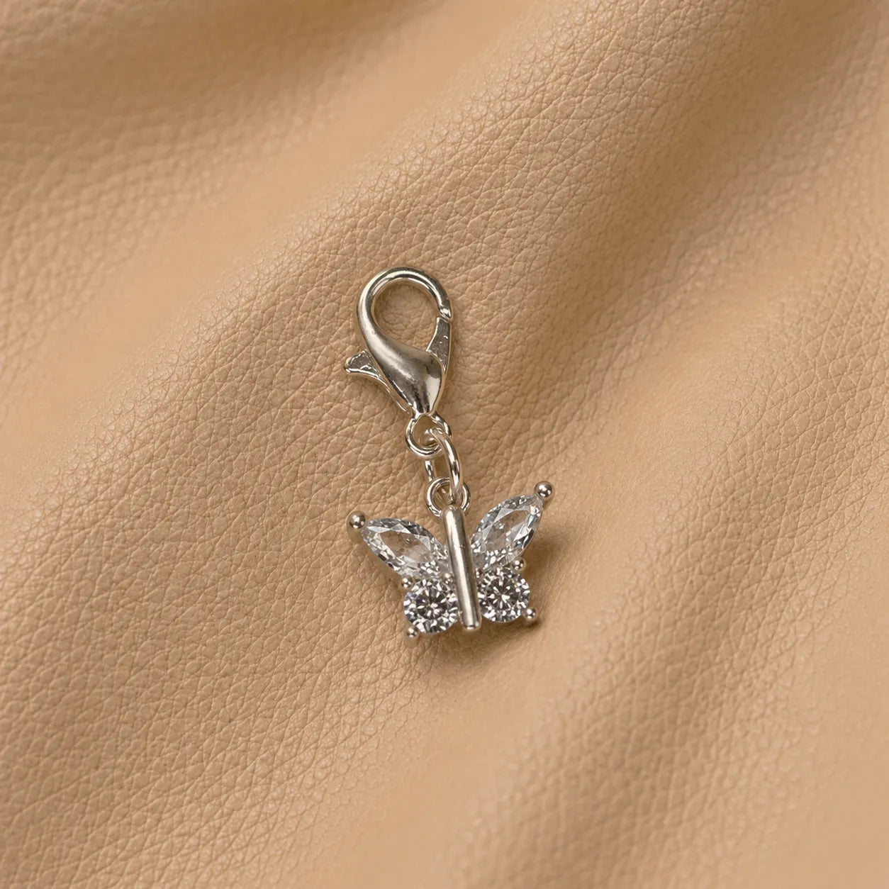 Butterfly journal charm attached to notebook elastic band, elegant metal accessory for planners and journals.