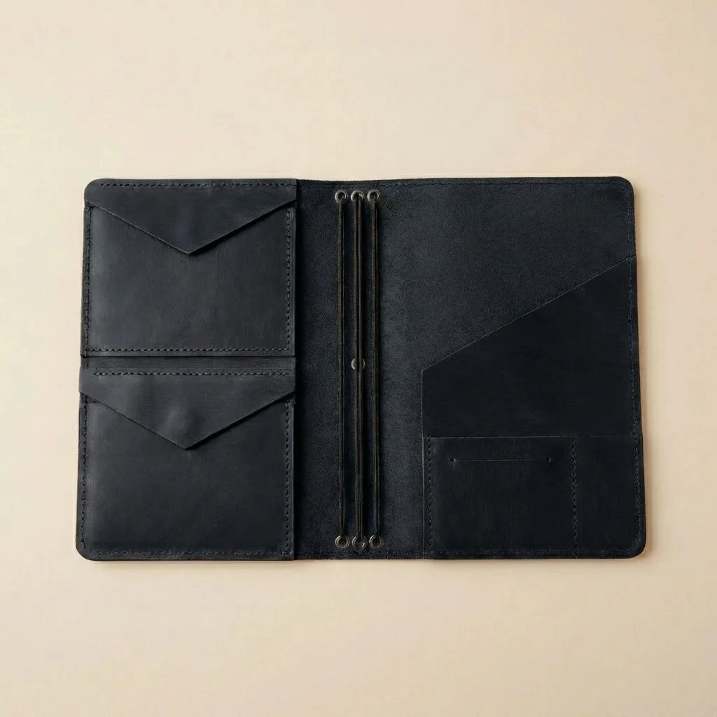 Black leather journal on a beige background