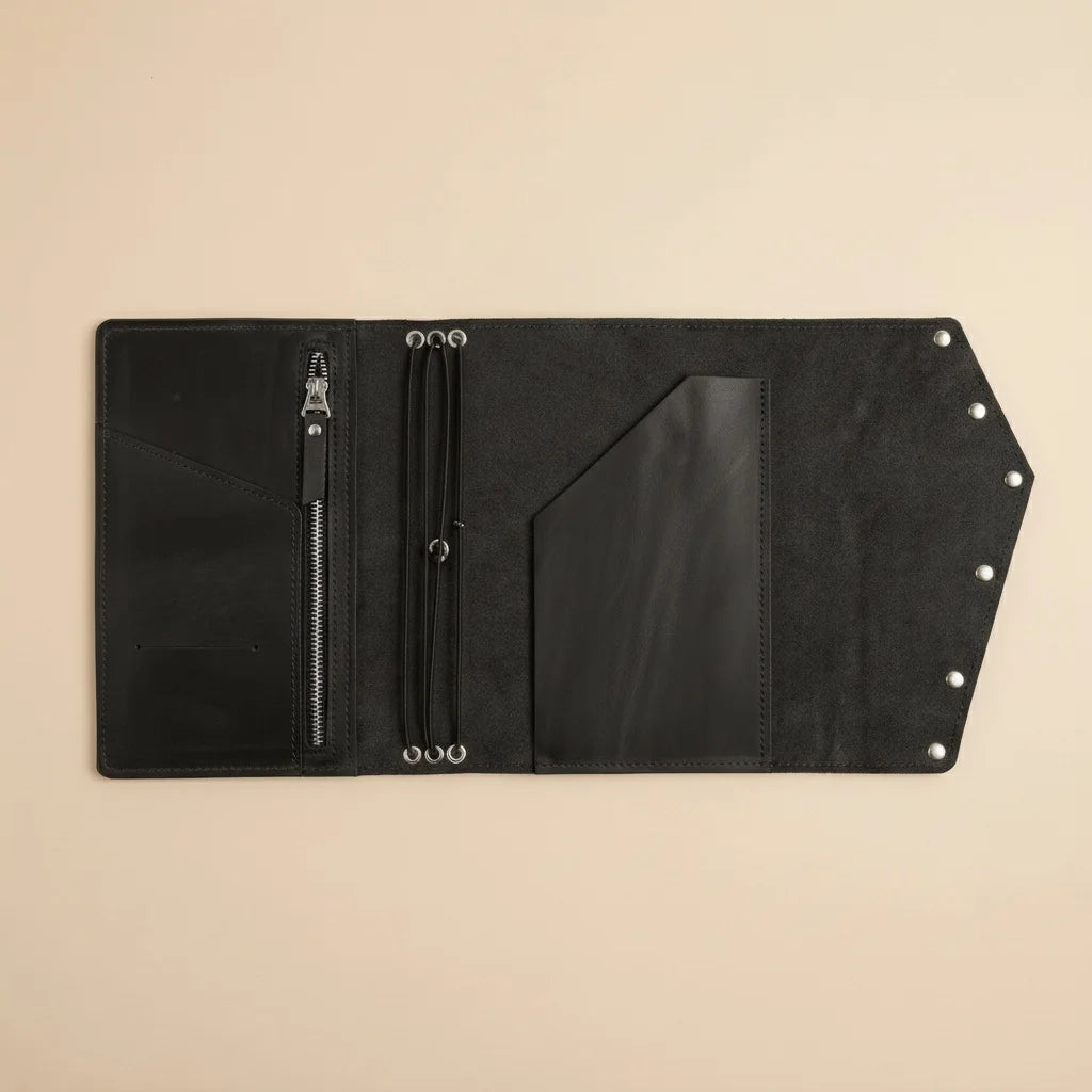 Black leather wallet with zipper on a beige background
