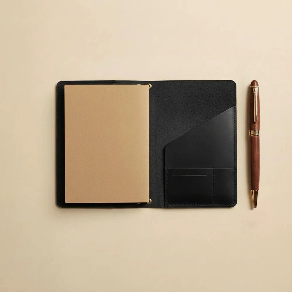 Genuine leather notebook organizer designed for refillable journals with interior storage pockets.