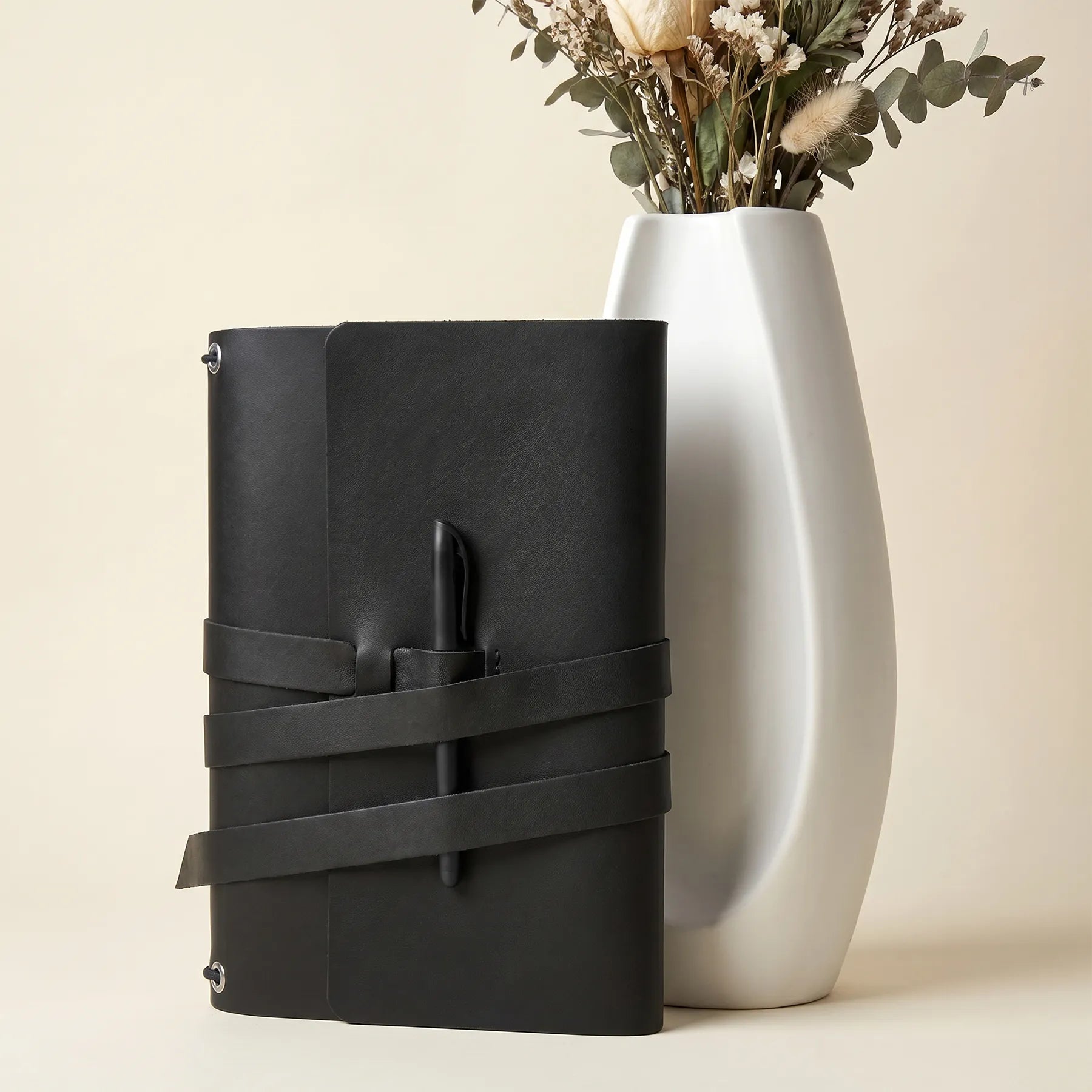 Handmade premium leather notebook cover featuring secure pen loops and elegant everyday functionality.