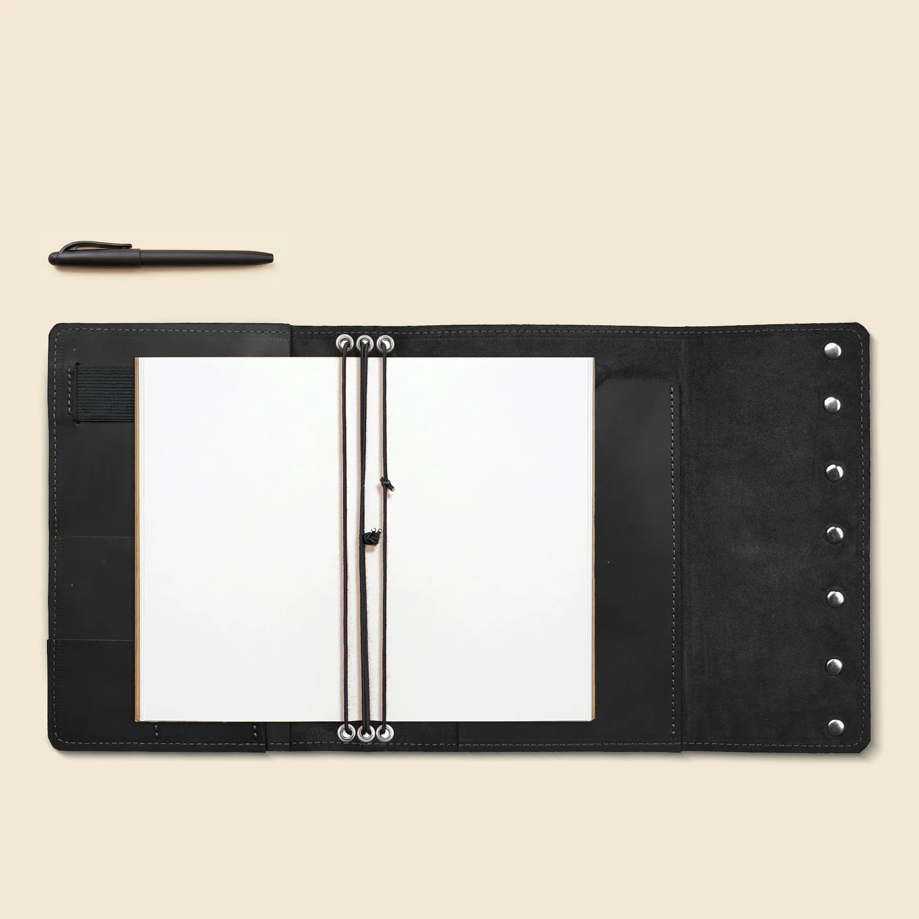 Leather notebook cover designed with pen loop and inner organization.