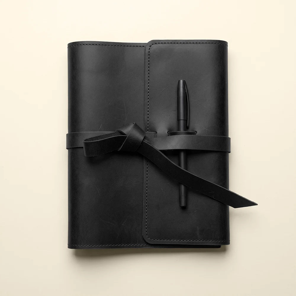 Rustic leather planner cover with spacious pockets and convenient pen holder.