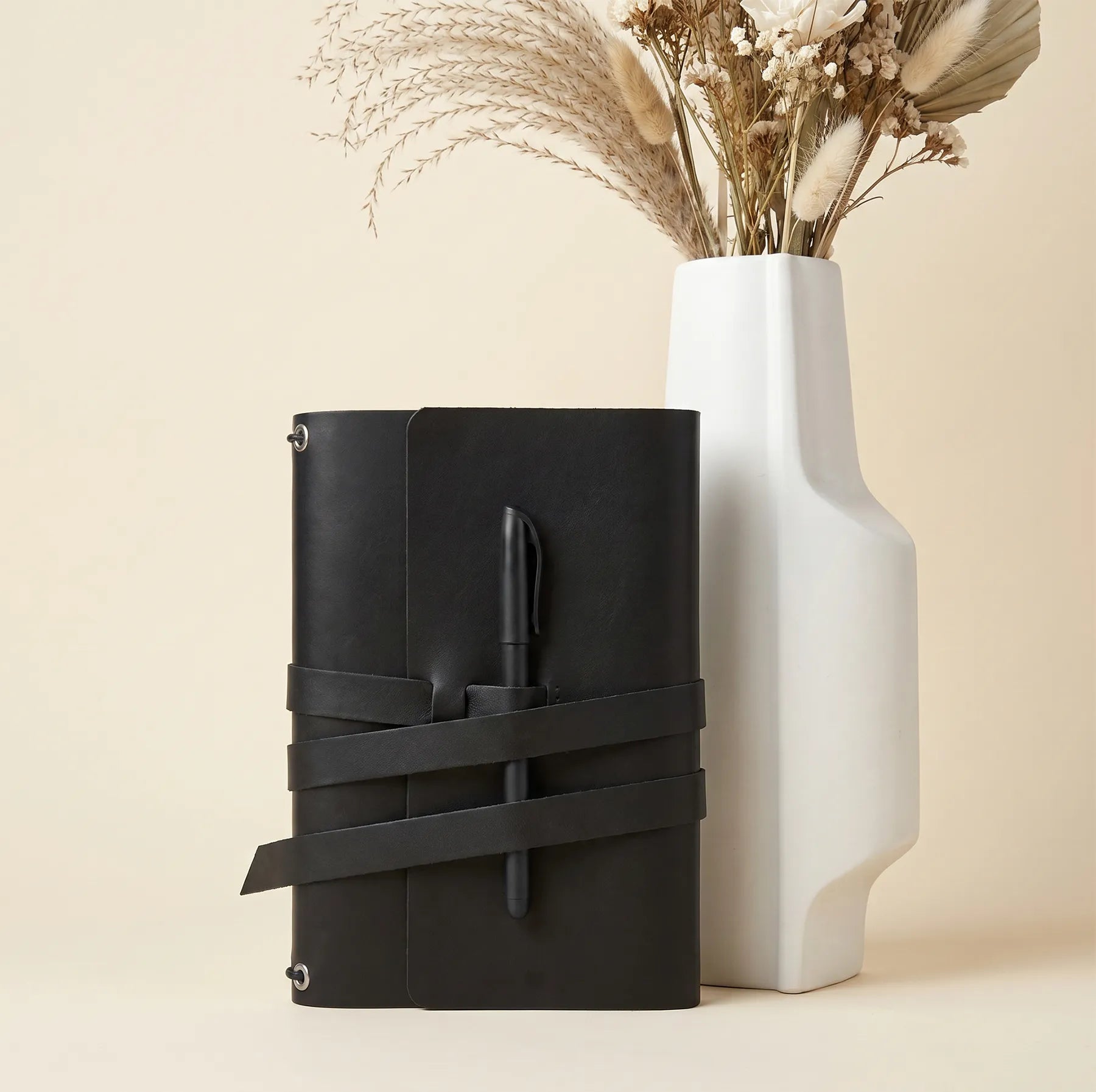 Leather journal cover with secure pen holders crafted from premium genuine natural leather.