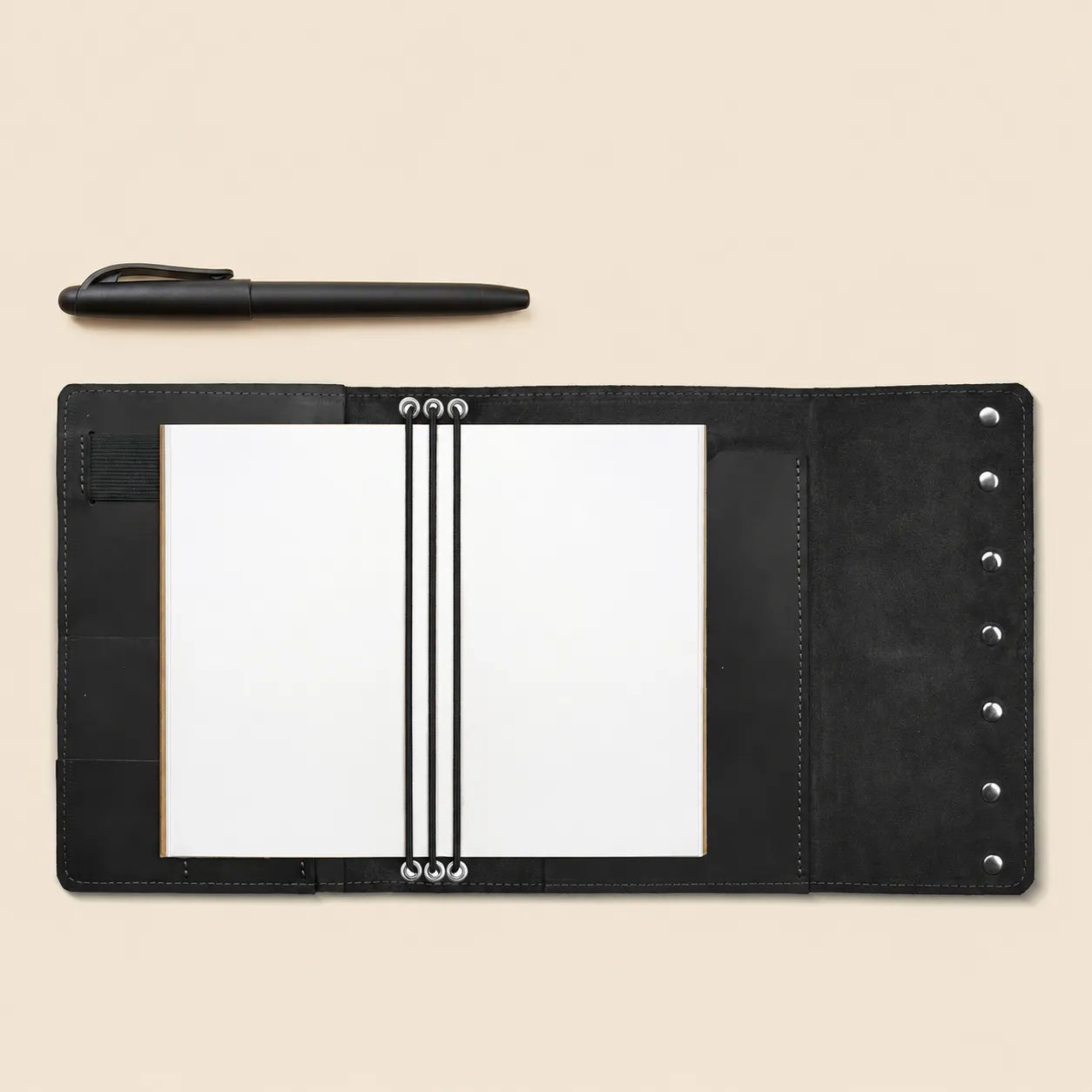 Refillable leather organizer cover with convenient pockets and dedicated pen holder.