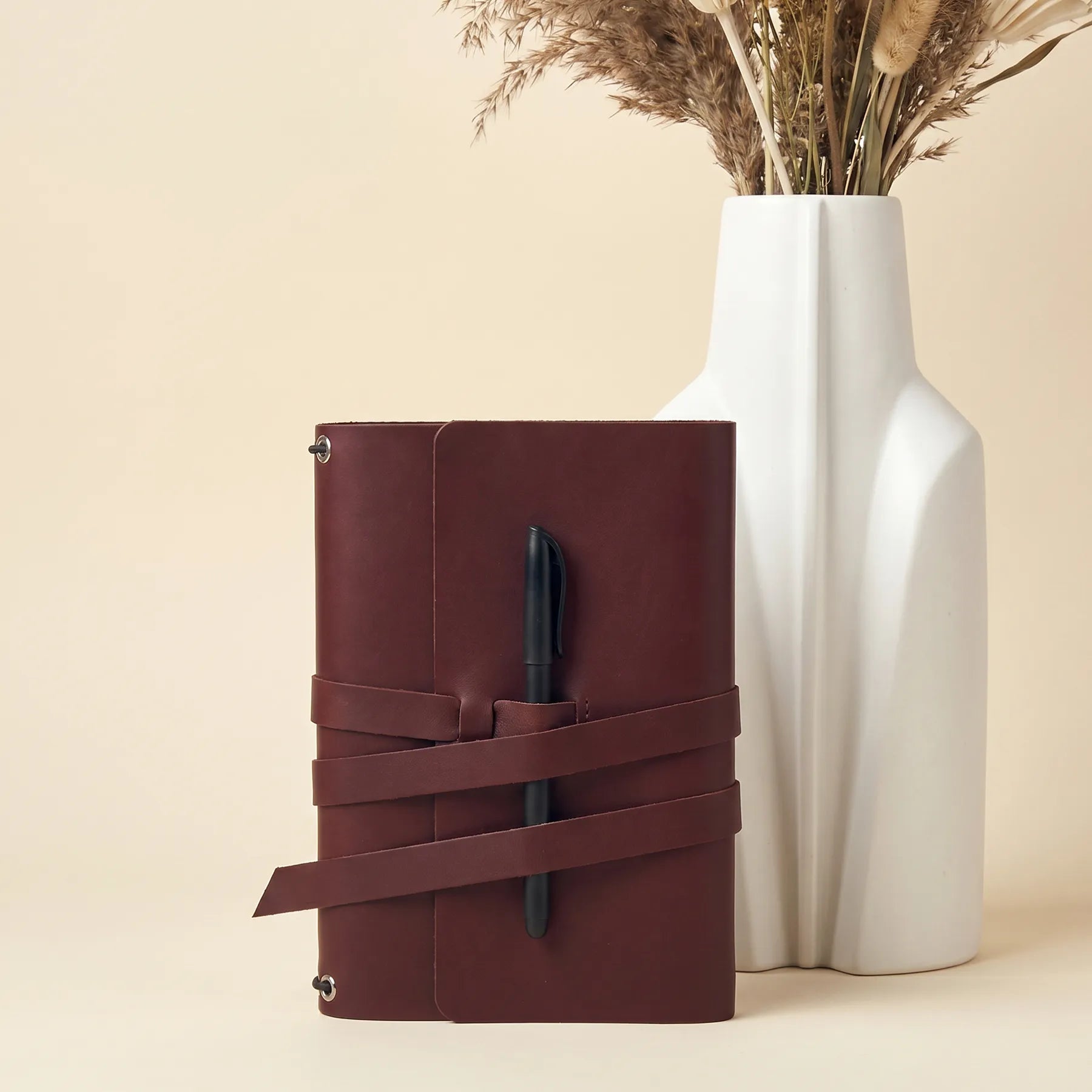 Handmade genuine leather journal cover featuring practical pen loops and timeless minimalist style.