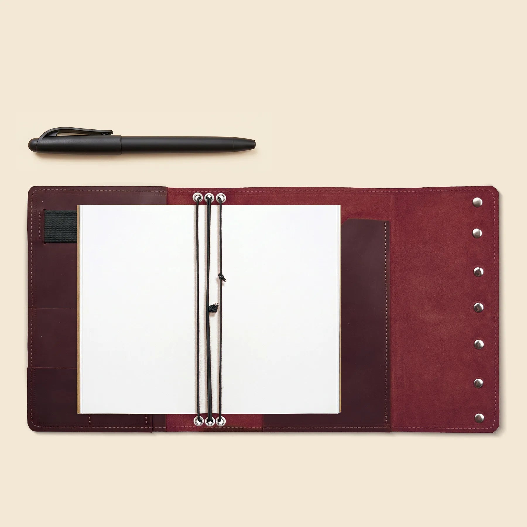 Handmade leather cover with three elastics, card slots, and pen loop.