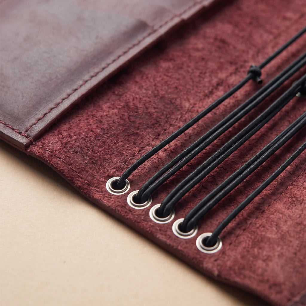 Leather notebook portfolio with multiple elastics and utility pockets