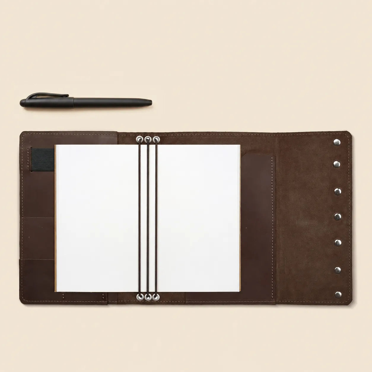 Leather journal organizer with interior card pockets and convenient pen holder.