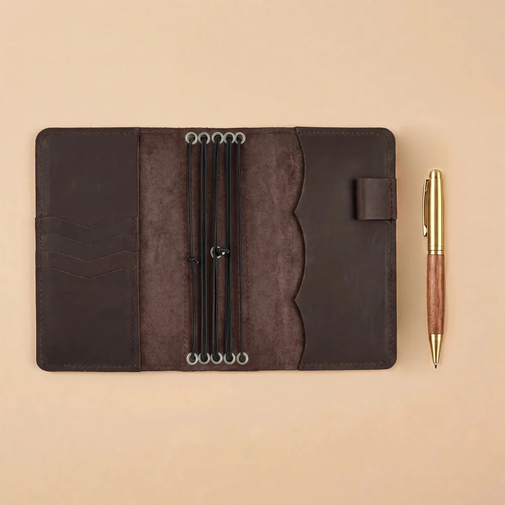 Leather journal organizer with elastic bands, card slots, and document storage pockets.