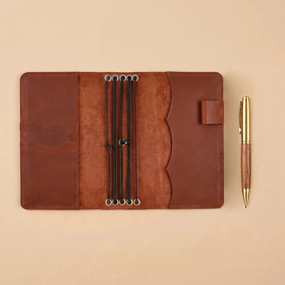 Rustic genuine leather notebook cover with refillable design and interior storage compartments.